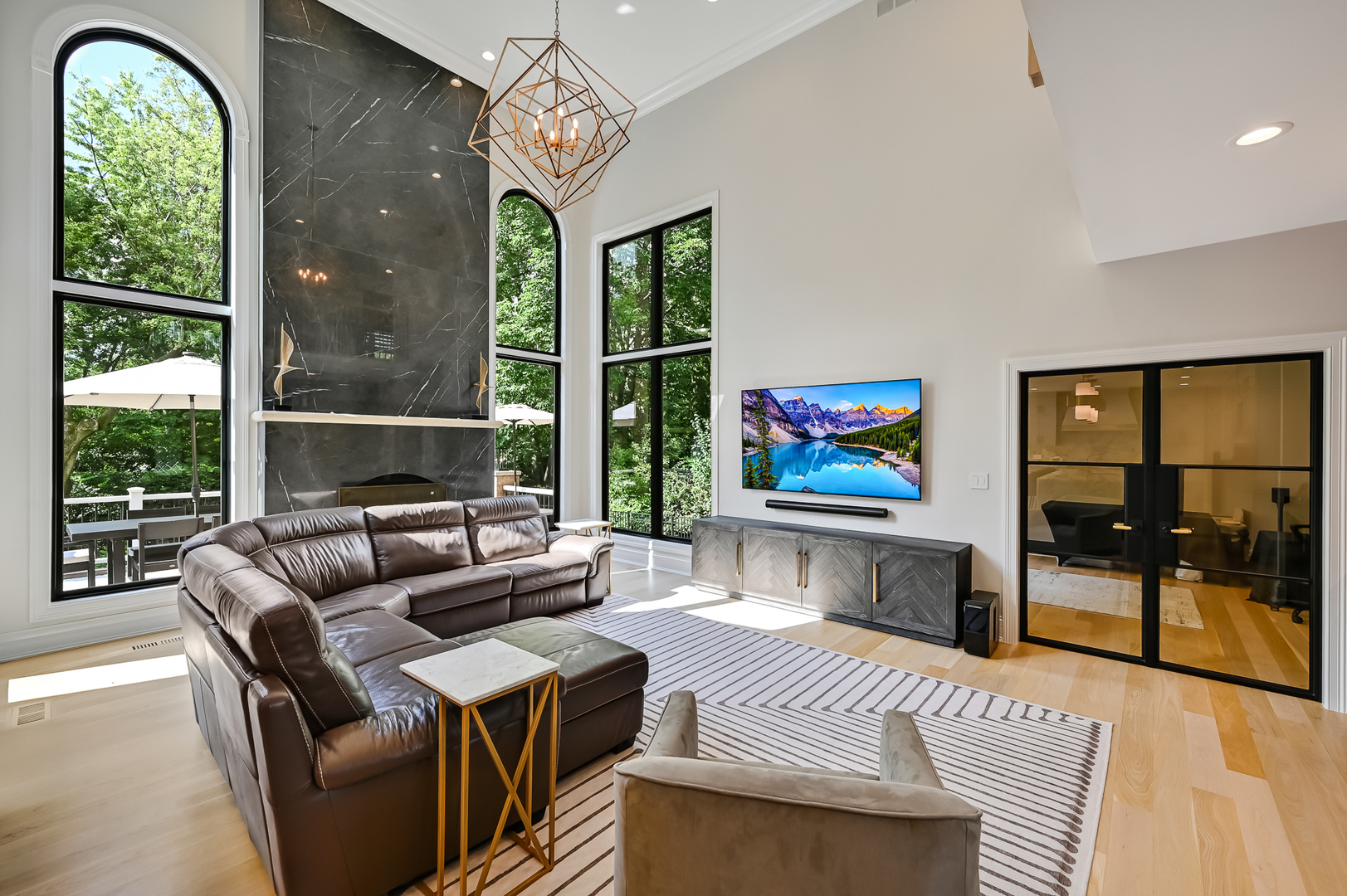 1813 Kelly Court Darien, IL 60561 - Photo 25 of 56 a living room with furniture a floor to ceiling window and a flat screen tv