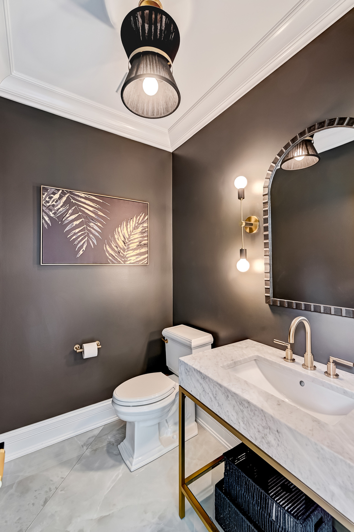 1813 Kelly Court Darien, IL 60561 - Photo 29 of 56 a bathroom with a granite countertop toilet a sink and mirror