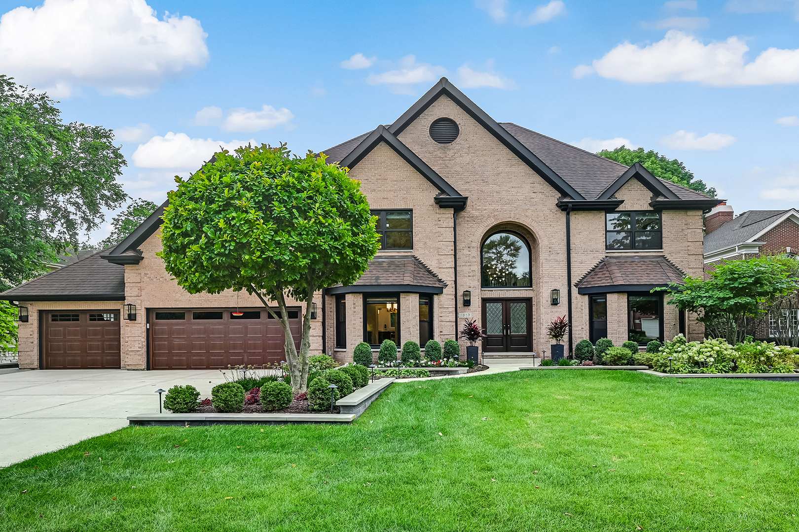 1813 Kelly Court Darien, IL 60561 - Photo 10 of 56 a front view of a house with a garden and plants