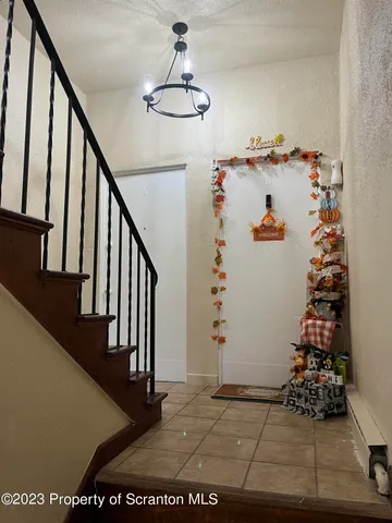 a view of entryway with stairs and wooden floor