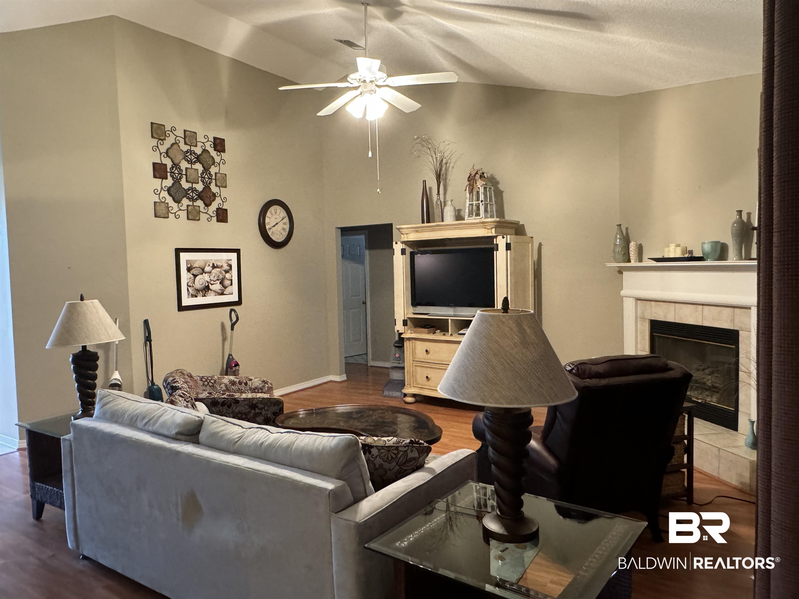 9139 Clubhouse Drive Foley, AL 36535 - Photo 11 of 30 Living room featuring a fireplace, ceiling fan, lofted ceiling, and hardwood / wood-style floors