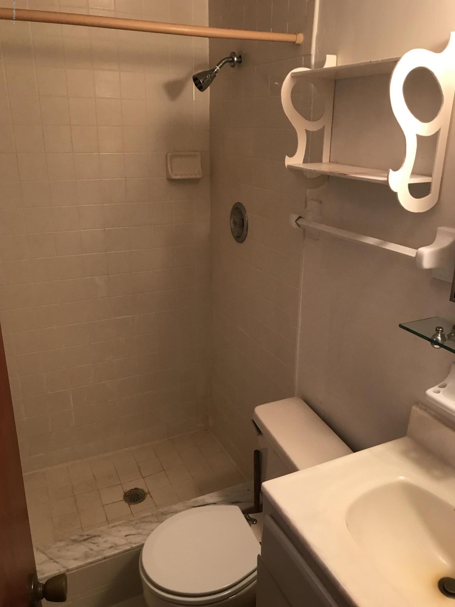 1032 Player Road Jacksonville, FL 32218 - Photo 5 of 12 a white toilet sitting next to a bathroom sink
