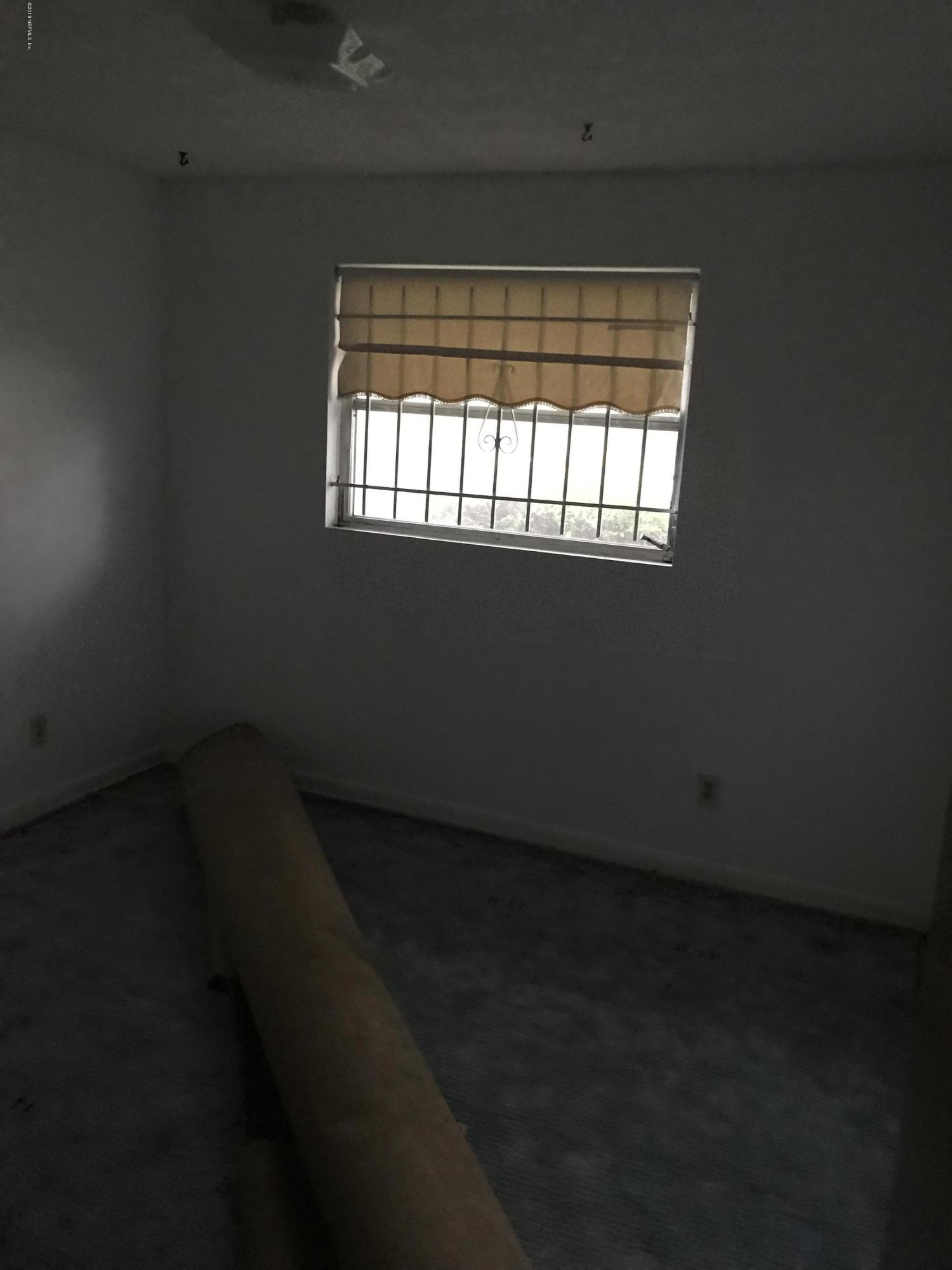1032 Player Road Jacksonville, FL 32218 - Photo 8 of 12 an empty room with a window