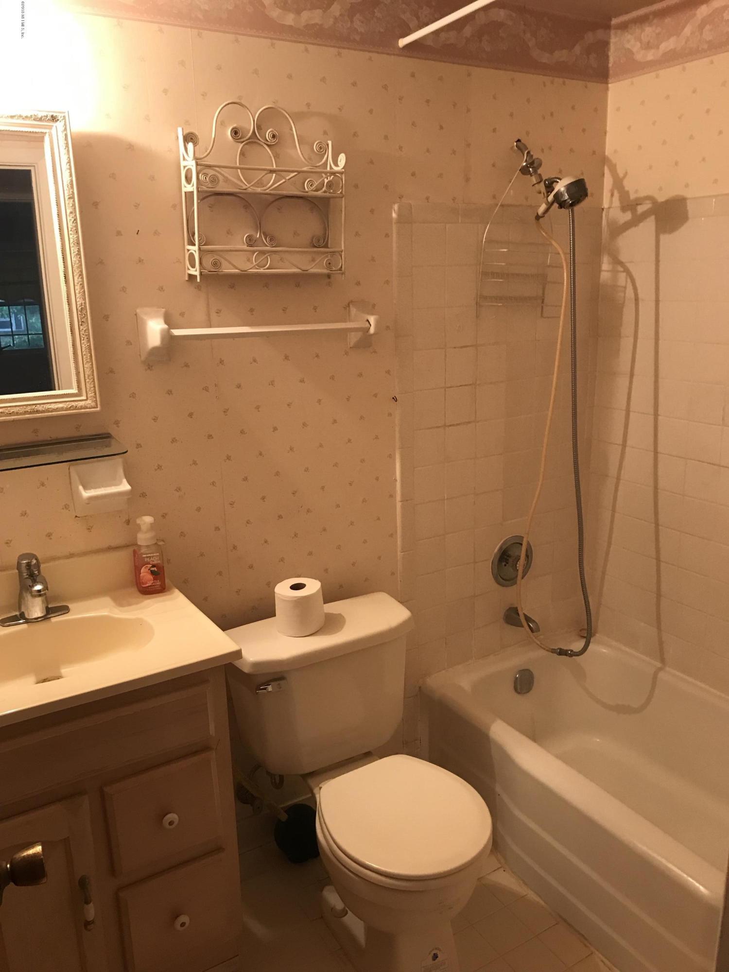 1032 Player Road Jacksonville, FL 32218 - Photo 10 of 12 a bathroom with a sink a toilet and shower