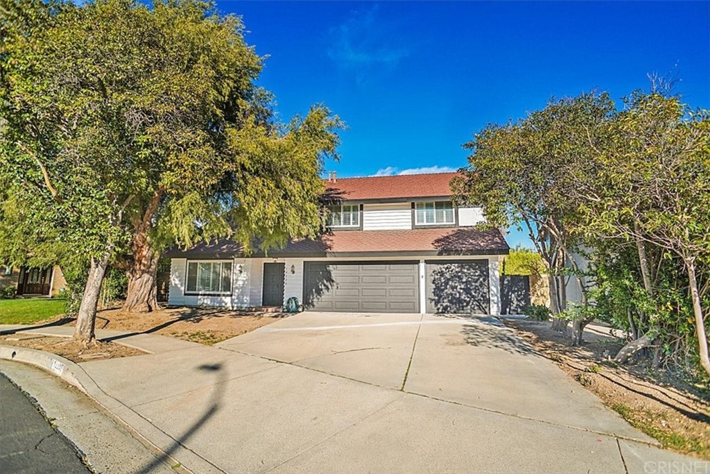 front view of a house with a tree