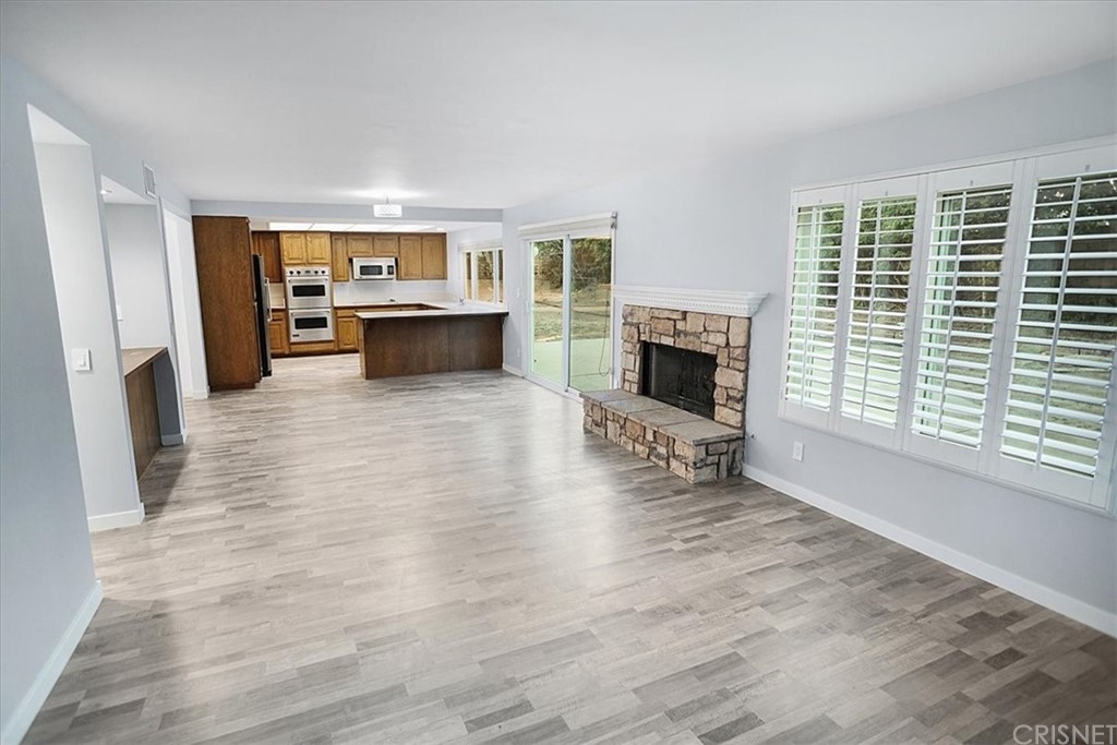 12230 Stewarton Drive Porter Ranch, CA 91326 - Photo 11 of 25 a living room with furniture and a fireplace