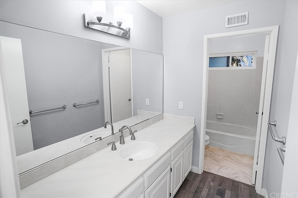 12230 Stewarton Drive Porter Ranch, CA 91326 - Photo 20 of 25 a bathroom with a sink a mirror and a shower