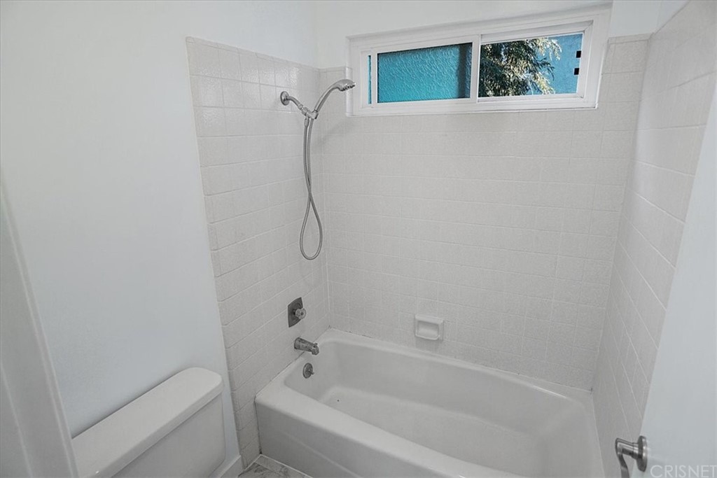 12230 Stewarton Drive Porter Ranch, CA 91326 - Photo 21 of 25 a white bath tub sitting next to a shower