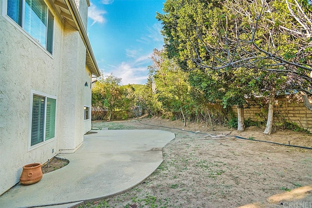 12230 Stewarton Drive Porter Ranch, CA 91326 - Photo 23 of 25 a view of a backyard with plants and trees