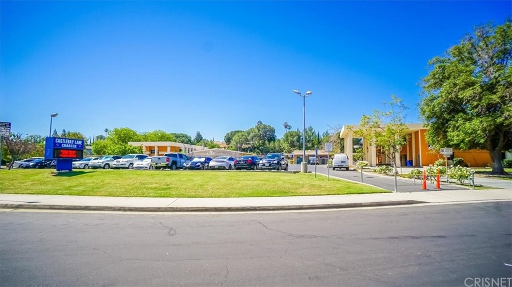 12230 Stewarton Drive Porter Ranch, CA 91326 - Photo 24 of 25 a view of a house with a big yard and a large trees