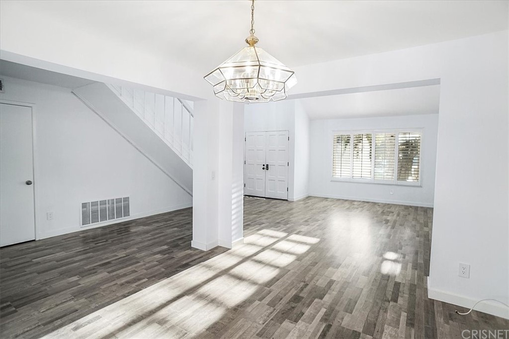 12230 Stewarton Drive Porter Ranch, CA 91326 - Photo 3 of 25 a view of empty room with wooden floor and fan