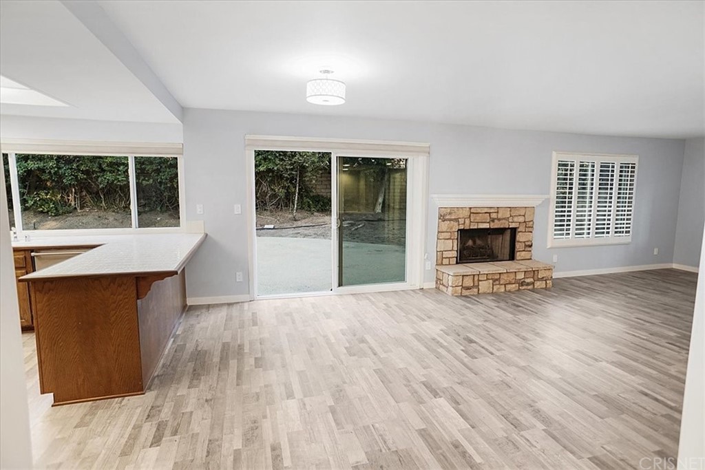 12230 Stewarton Drive Porter Ranch, CA 91326 - Photo 6 of 25 an empty room with wooden floor and a window