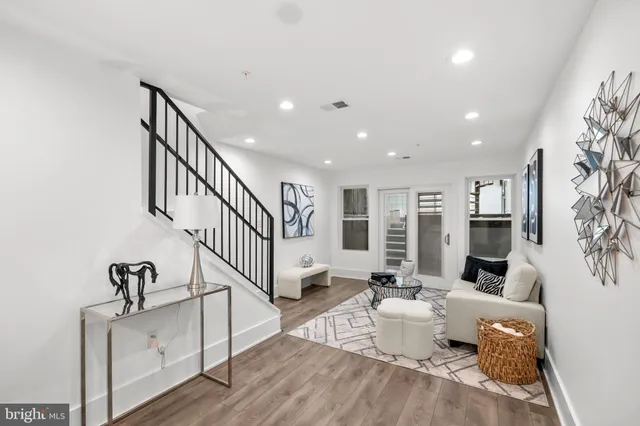 a living room with furniture windows and a ceiling fan