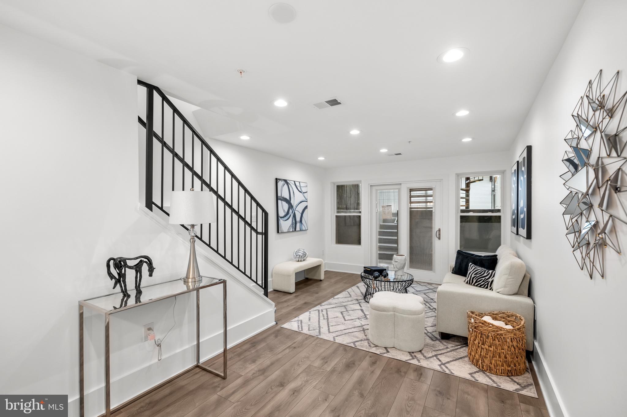a living room with furniture windows and a ceiling fan