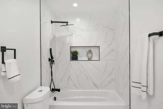 a bathroom with a bathtub and a shower