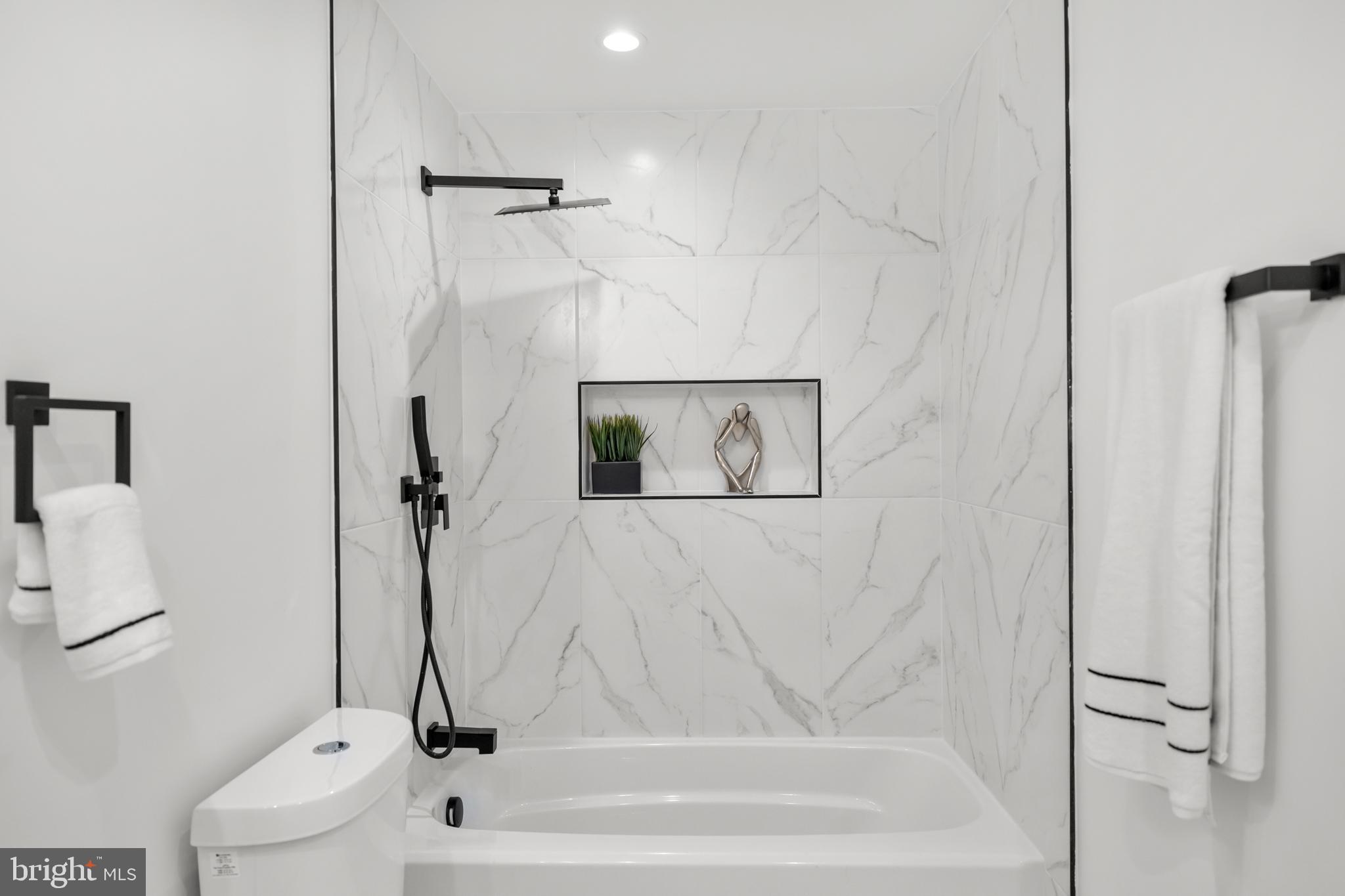 113 18th Street Southeast, Unit 1 Washington, DC 20003 - Photo 15 of 37 a bathroom with a bathtub and a shower