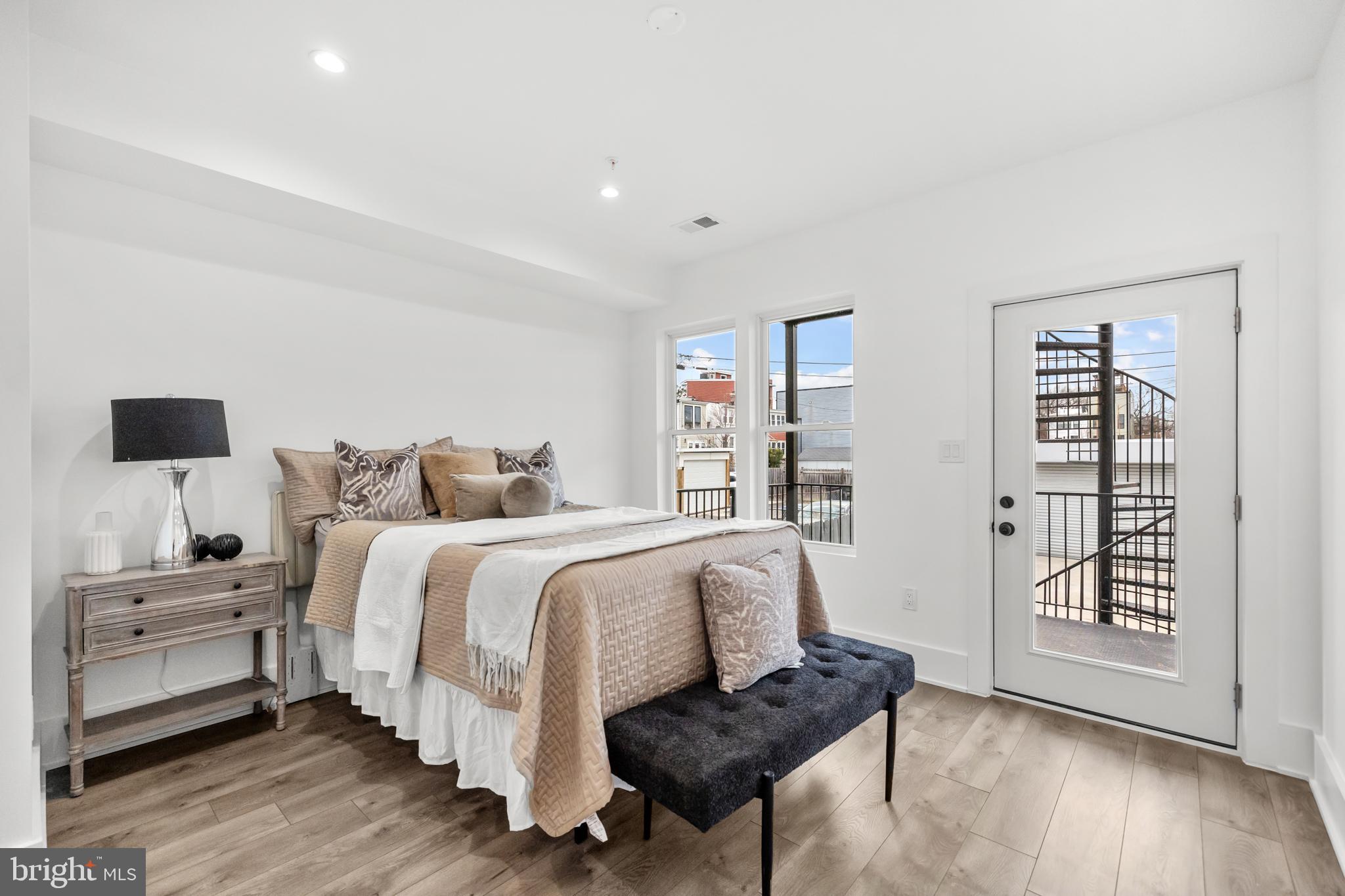 113 18th Street Southeast, Unit 1 Washington, DC 20003 - Photo 16 of 37 a spacious bedroom with a bed and wooden floor