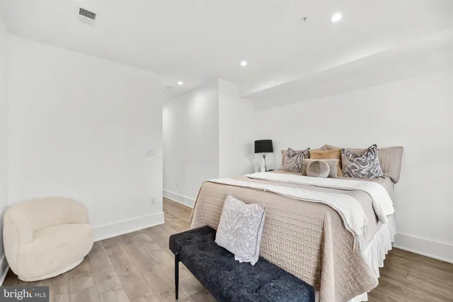 a bedroom with a bed and a chair