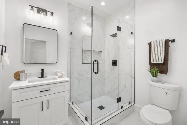 a bathroom with a sink toilet and shower