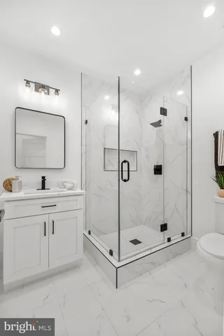 a bathroom with a shower a sink and mirror
