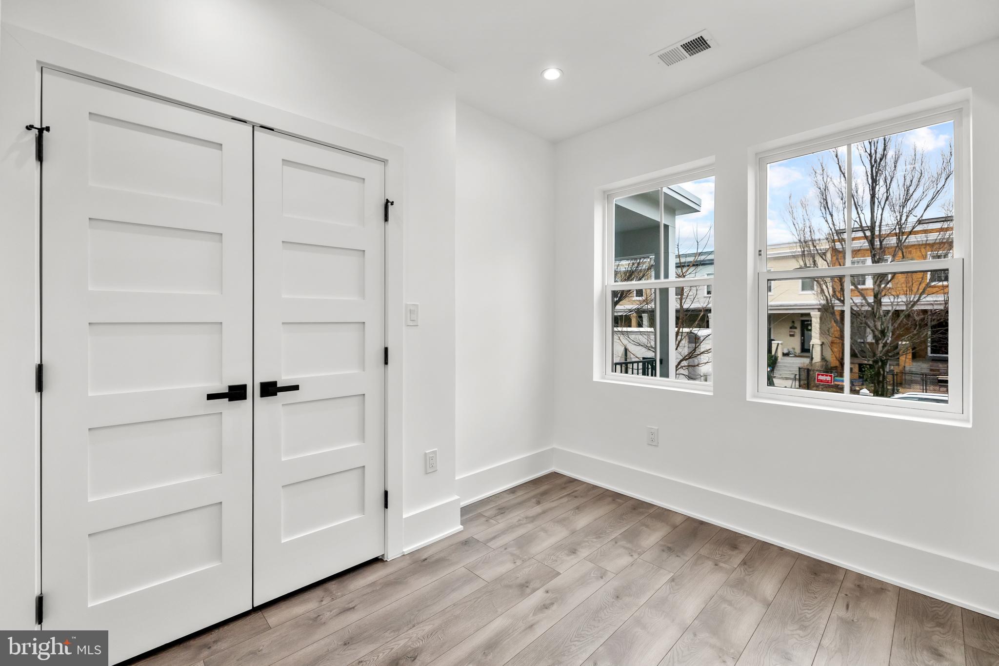 113 18th Street Southeast, Unit 1 Washington, DC 20003 - Photo 22 of 37 a view of an empty room with a window and wooden floor