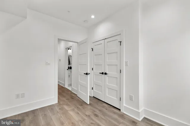 a view of a hallway with wooden floor