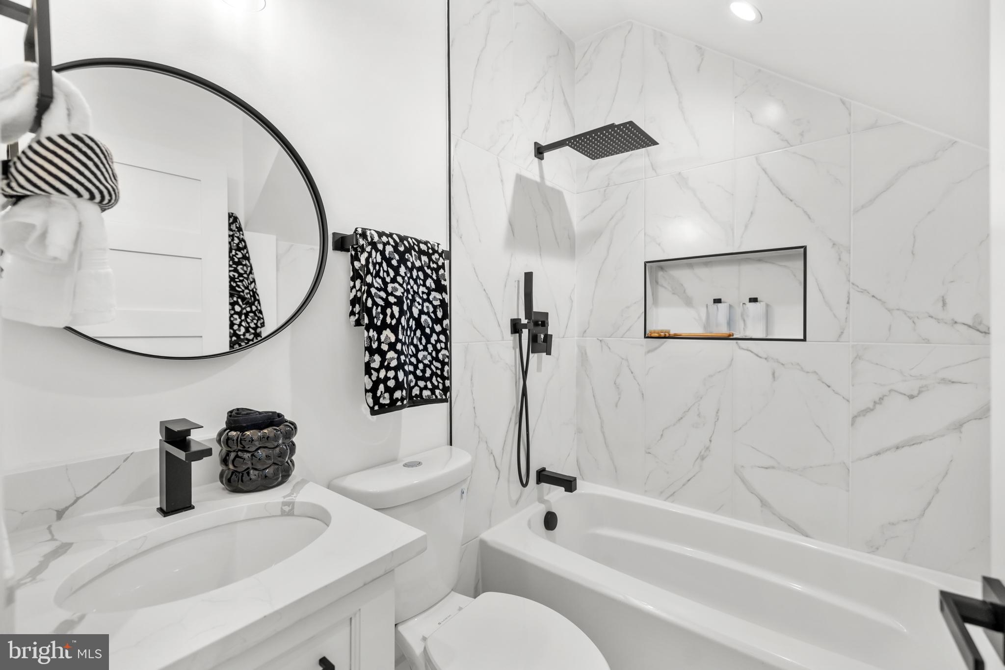 113 18th Street Southeast, Unit 1 Washington, DC 20003 - Photo 24 of 37 a bathroom with a sink a toilet and a mirror