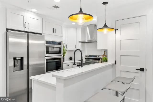 a kitchen with a refrigerator and a sink