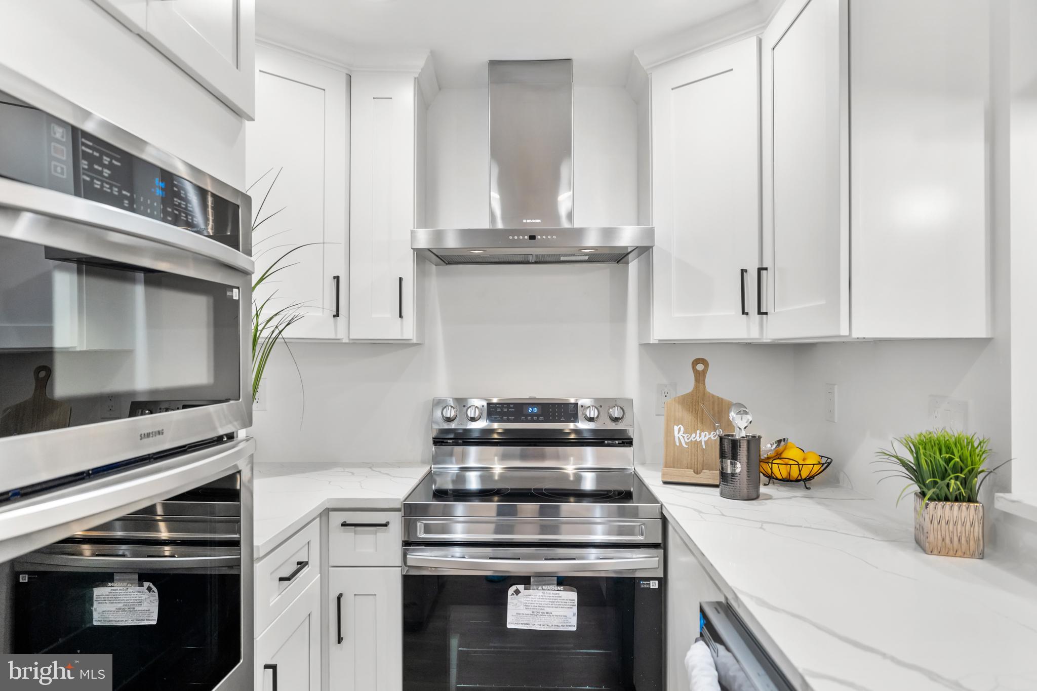 113 18th Street Southeast, Unit 1 Washington, DC 20003 - Photo 9 of 37 a kitchen with stainless steel appliances granite countertop a stove a white cabinets and a granite counter tops