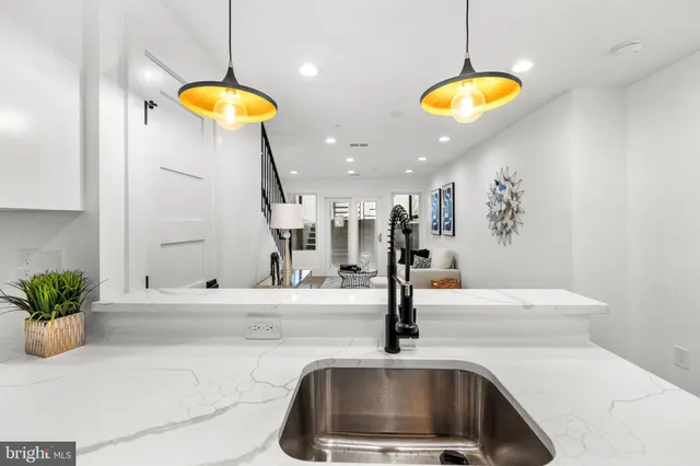 a kitchen with a sink and a chandelier