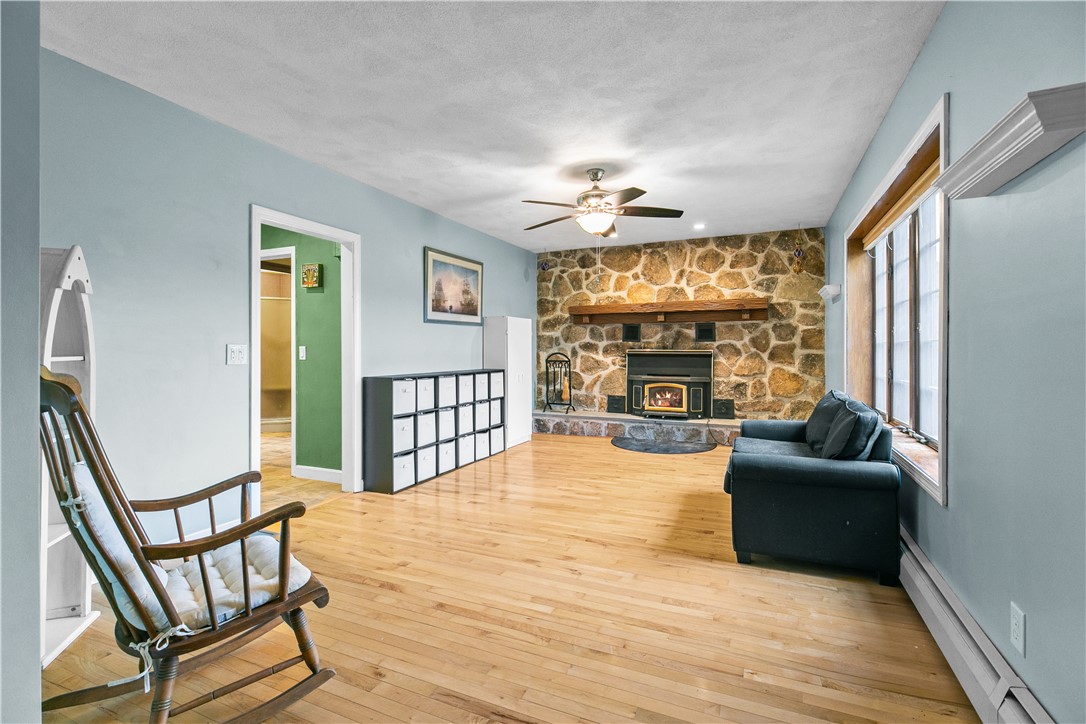 831 Crandall Road Tiverton, RI 02878 - Photo 18 of 50 Formal Living Room with Stone Fireplace & Wood stove