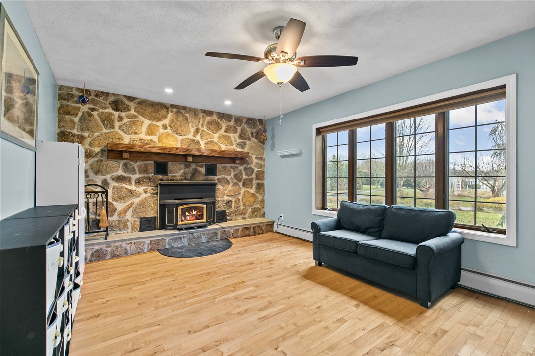831 Crandall Road Tiverton, RI 02878 - Photo 19 of 50 Formal Living Room with Stone Fireplace & Wood stove