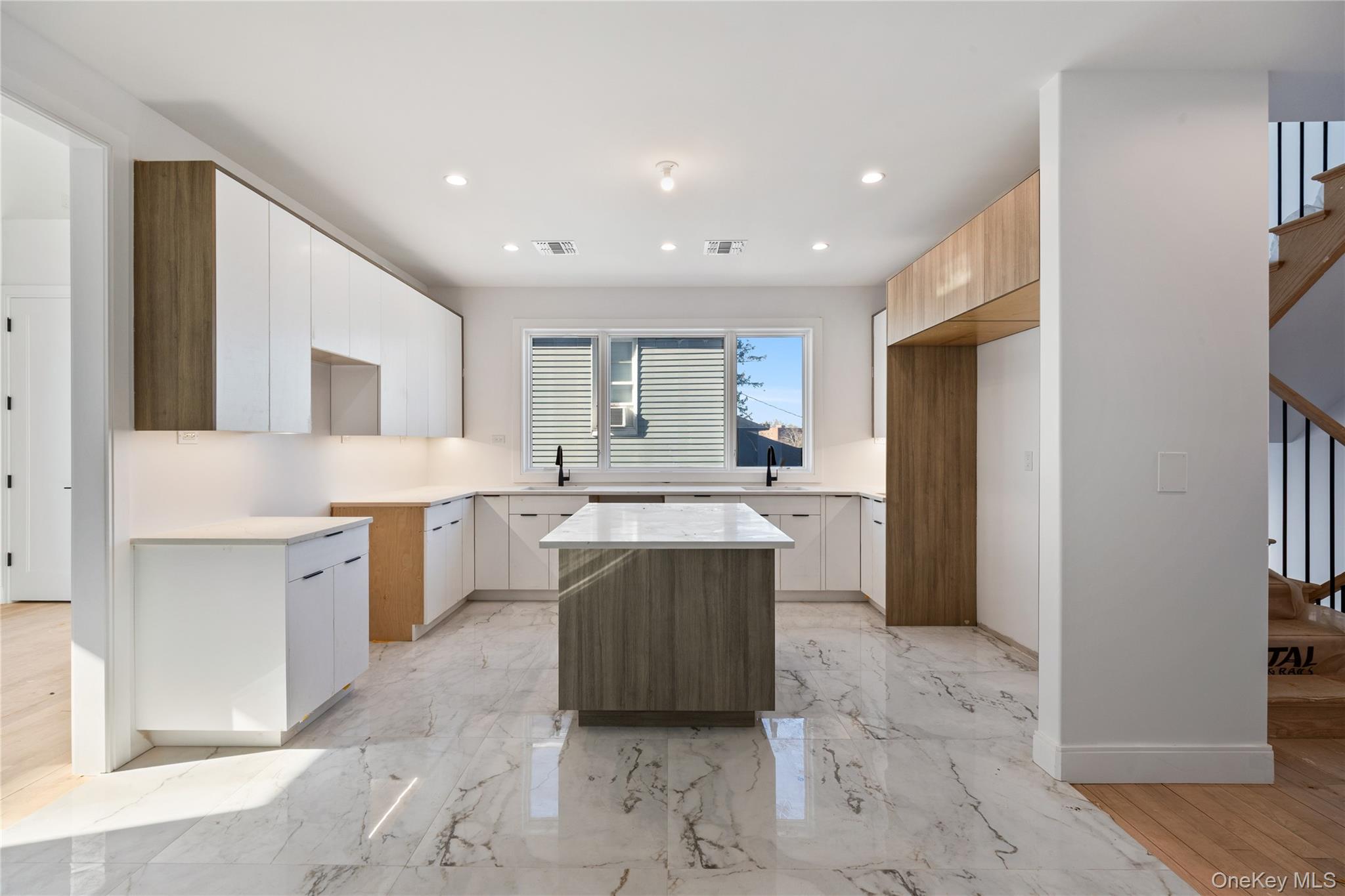 20 West Funston Avenue, Unit 212 Spring Valley, NY 10977 - Photo 12 of 34 a large kitchen with a large counter top a sink a window and stainless steel appliances