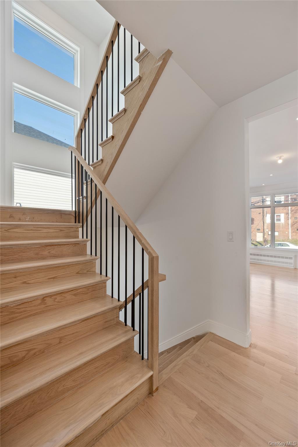 20 West Funston Avenue, Unit 212 Spring Valley, NY 10977 - Photo 16 of 34 a view of staircase with wooden floor and a window