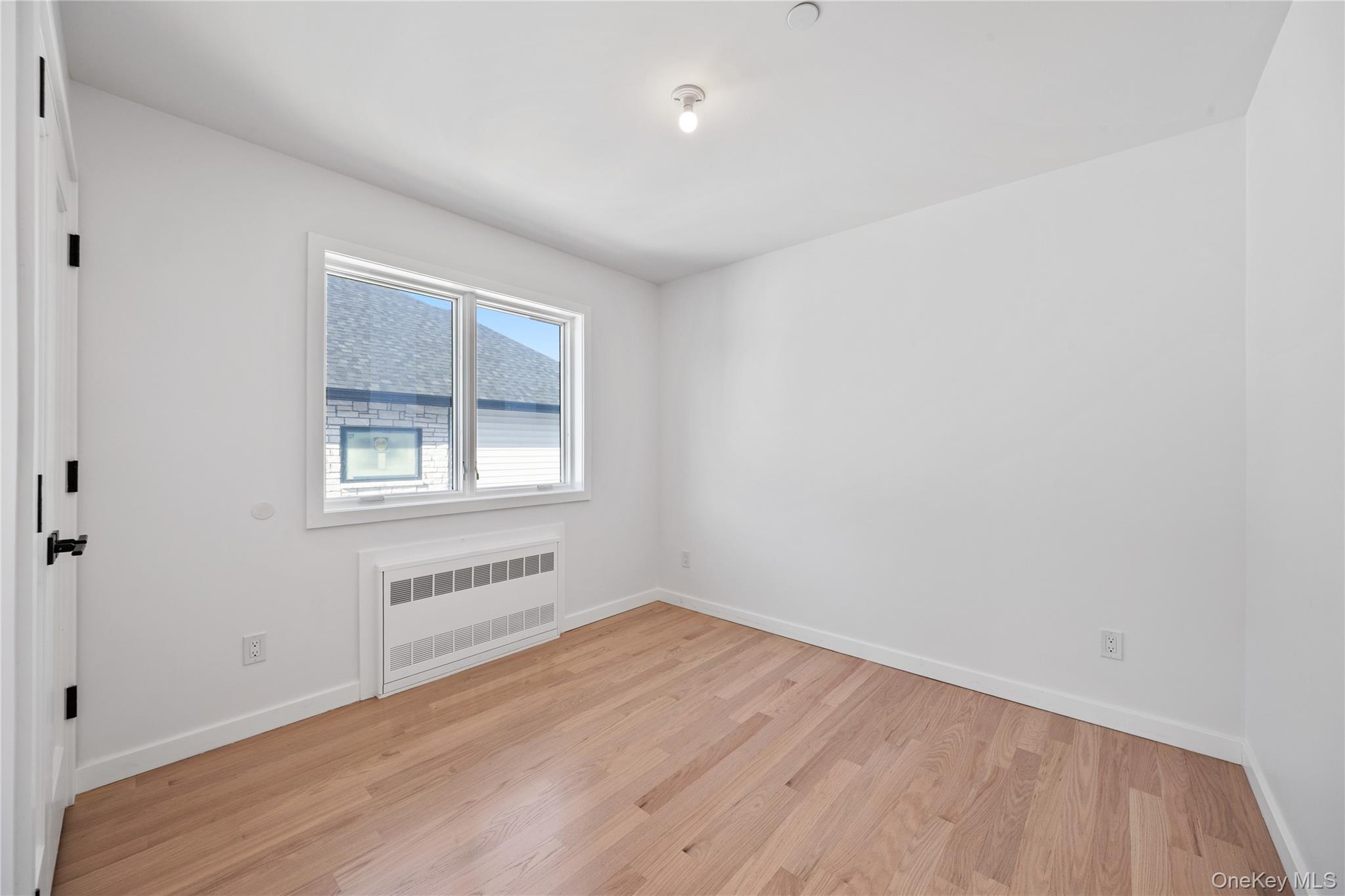 20 West Funston Avenue, Unit 212 Spring Valley, NY 10977 - Photo 24 of 34 an empty room with wooden floor and windows