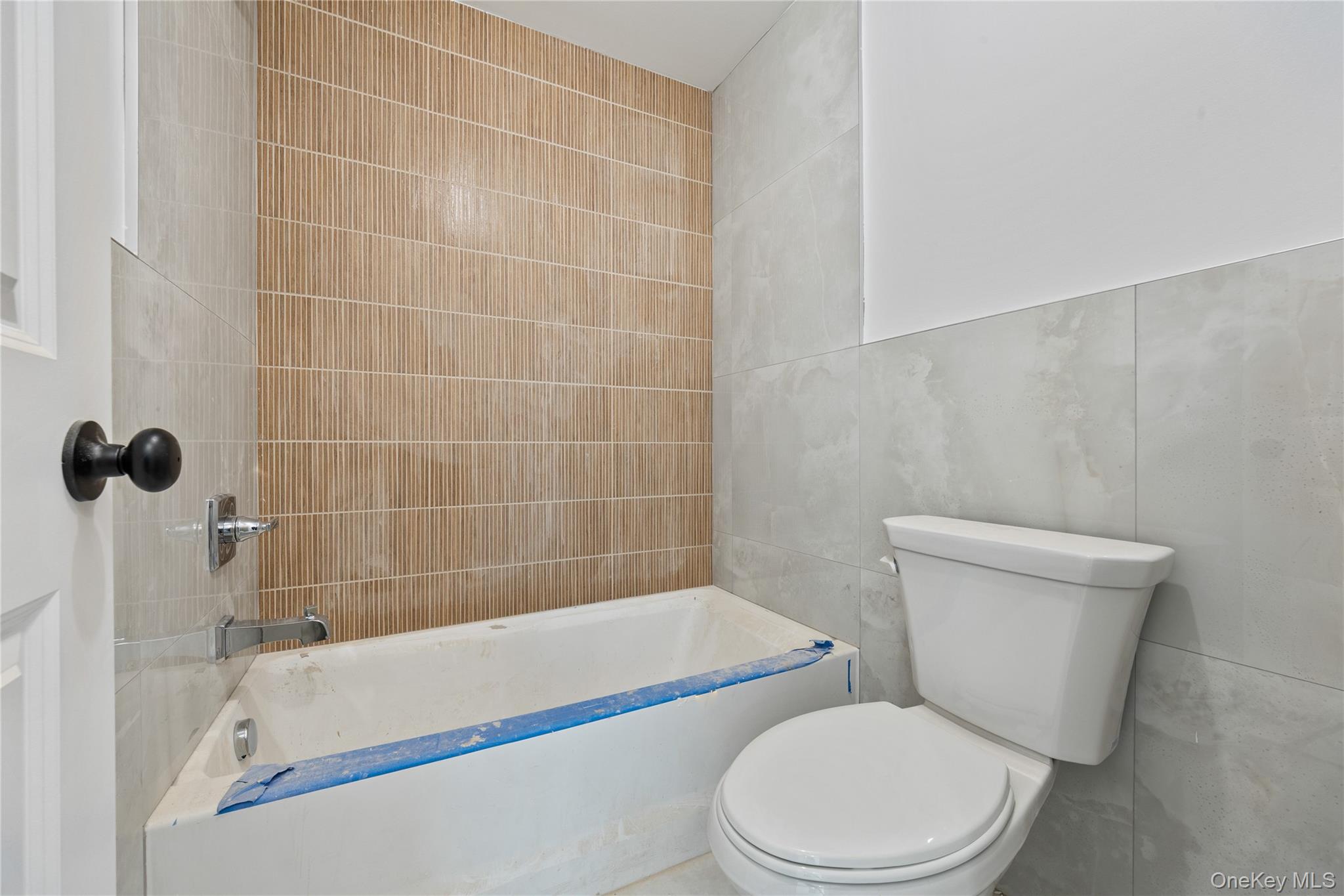 20 West Funston Avenue, Unit 212 Spring Valley, NY 10977 - Photo 29 of 34 a white toilet and tub sitting next to a bathroom sink