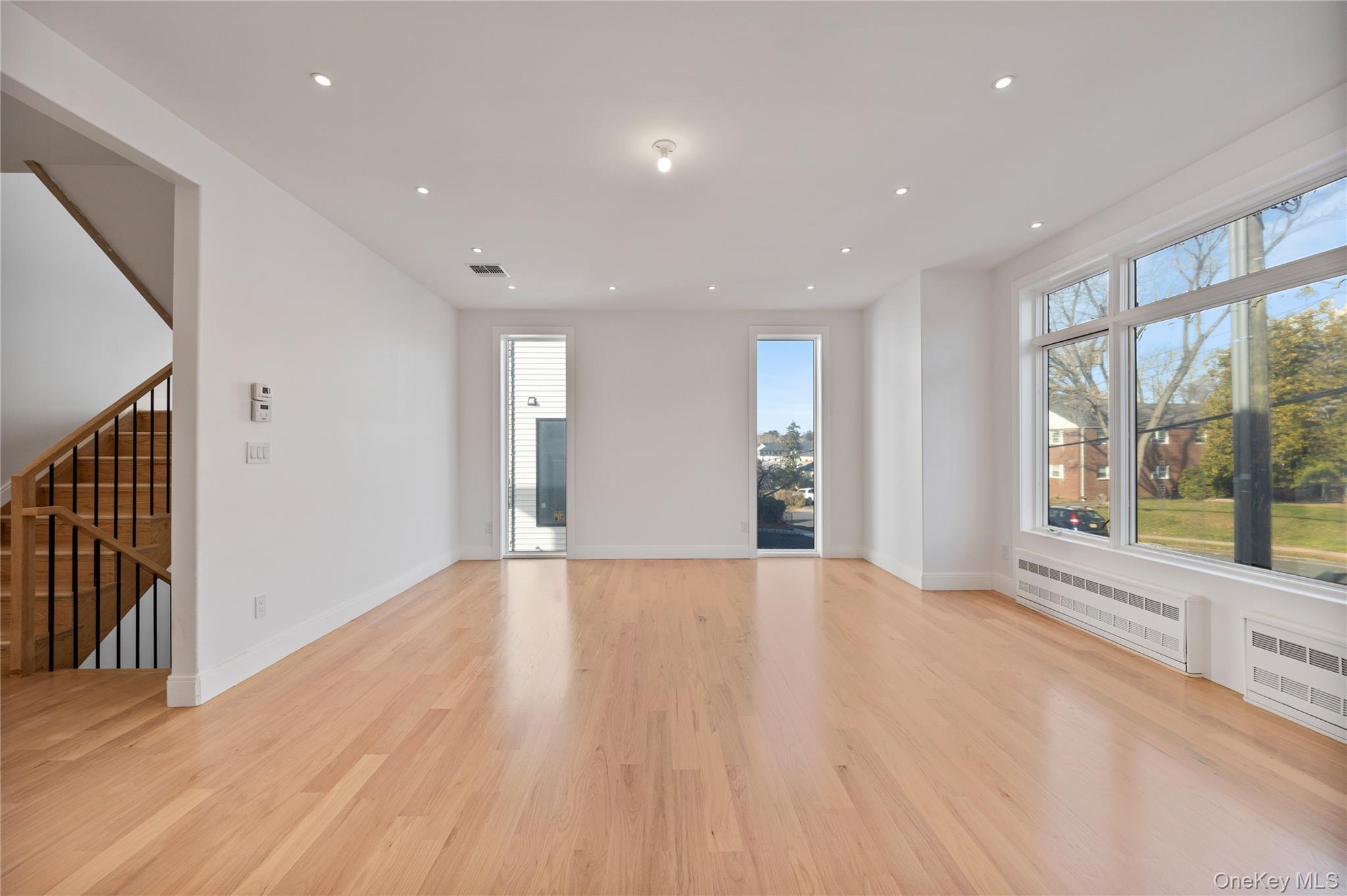 20 West Funston Avenue, Unit 212 Spring Valley, NY 10977 - Photo 8 of 34 a view of an empty room with wooden floor and a window