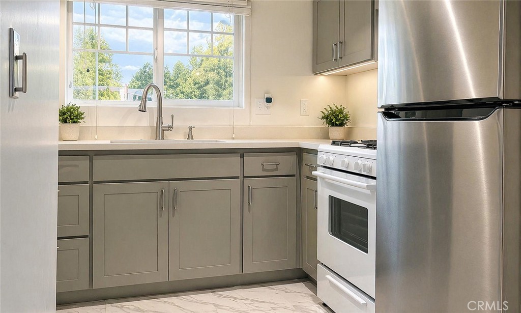 17490 Poplar Atascadero, CA 93422 - Photo 20 of 24 a kitchen with stainless steel appliances a refrigerator sink and cabinets
