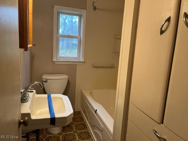 11423 Colburn Road Painesville, OH 44077 - Photo 15 of 16 Bathroom with a tub to relax in, sink, tile patterned flooring, and toilet
