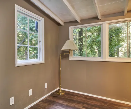 a view of a room with wooden floor and a window