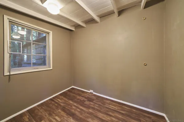 a view of room with window and hardwood floor