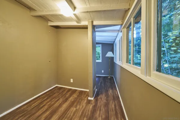 a view of a room with wooden floor and a balcony