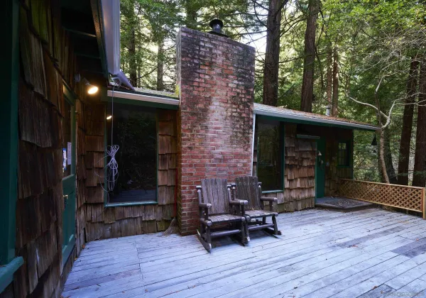 a view of a patio with table and chairs with wooden floor and fence