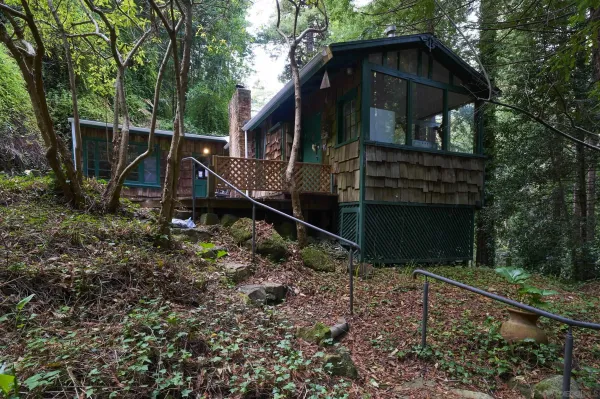 a backyard of a house with wooden fence and porch