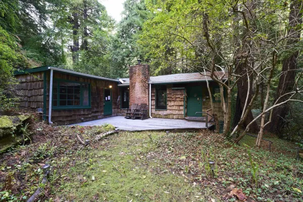 a view of a chair and table in backyard of the house