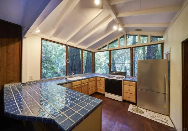 a kitchen with sink refrigerator and window