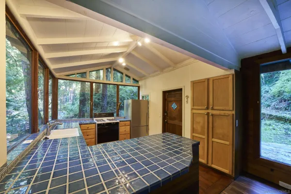 a room with wooden floor and large windows
