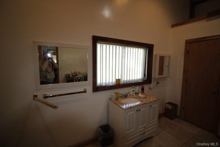 13 Creamery Road Livingston Manor, NY 12758 - Photo 20 of 23 Bathroom with light tile patterned floors and vanity