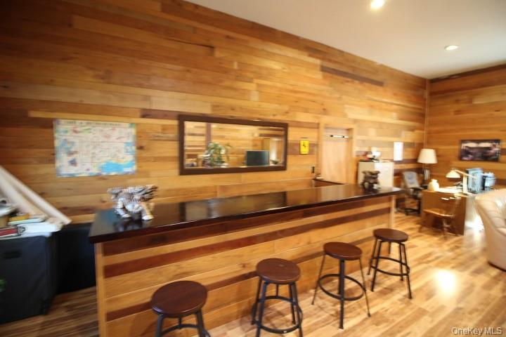 13 Creamery Road Livingston Manor, NY 12758 - Photo 8 of 22 Indoor dry bar featuring light wood-style floors, wood walls, and butcher block counters