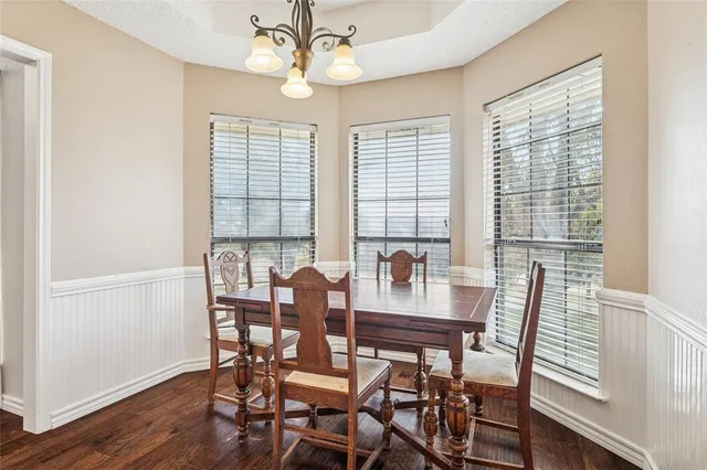 a view of a dining room with furniture window and wooden floor